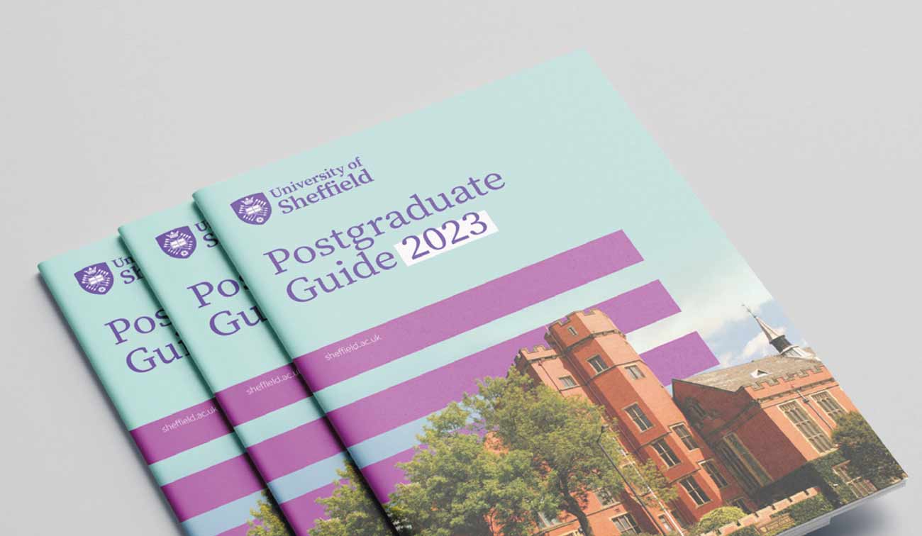 A printed "Postgraduate Guide 2023" featuring a campus image on the cover, arranged in a stacked layout.
