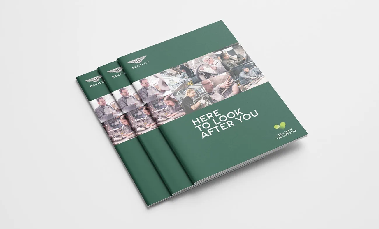A stack of brochures featuring a dark green cover, the tagline "Here to Look After You," and a collage of employee images, with Bentley branding.