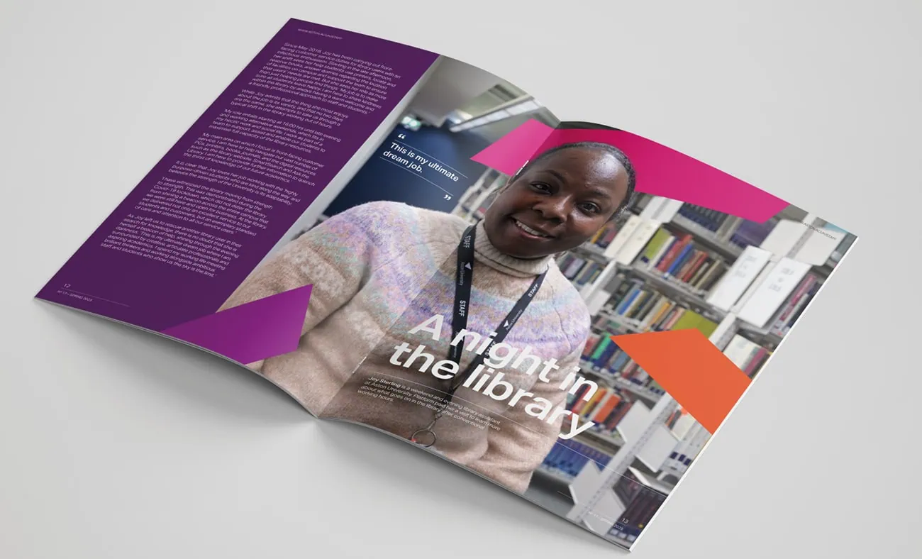 An open magazine spread featuring a profile of a smiling woman in a library. The headline reads "A night in the library," accompanied by bold geometric shapes in pink and orange. The left page contains a block of text on a purple background, while the right page showcases bookshelves in the background, adding context to the feature.