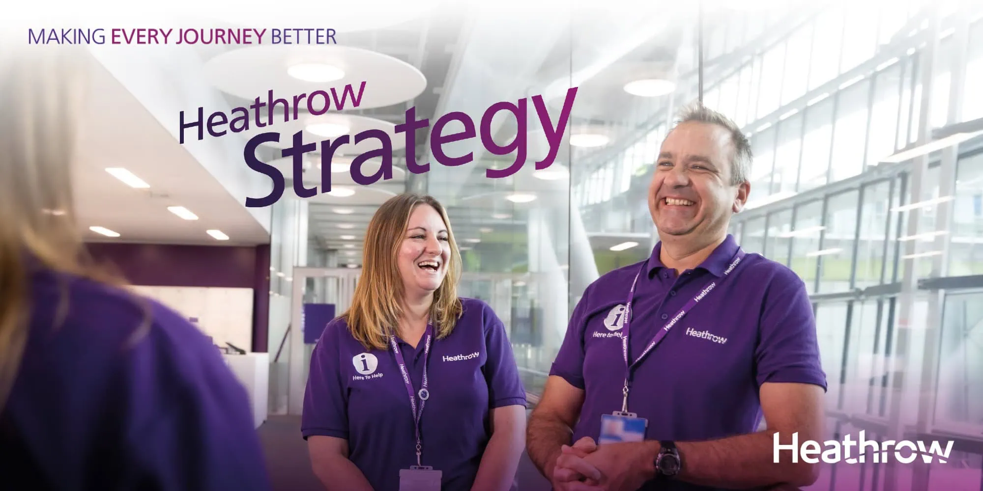 Two smiling Heathrow employees wearing purple uniforms stand in a modern, light-filled space, with the text "Heathrow Strategy" and the tagline "Making Every Journey Better".