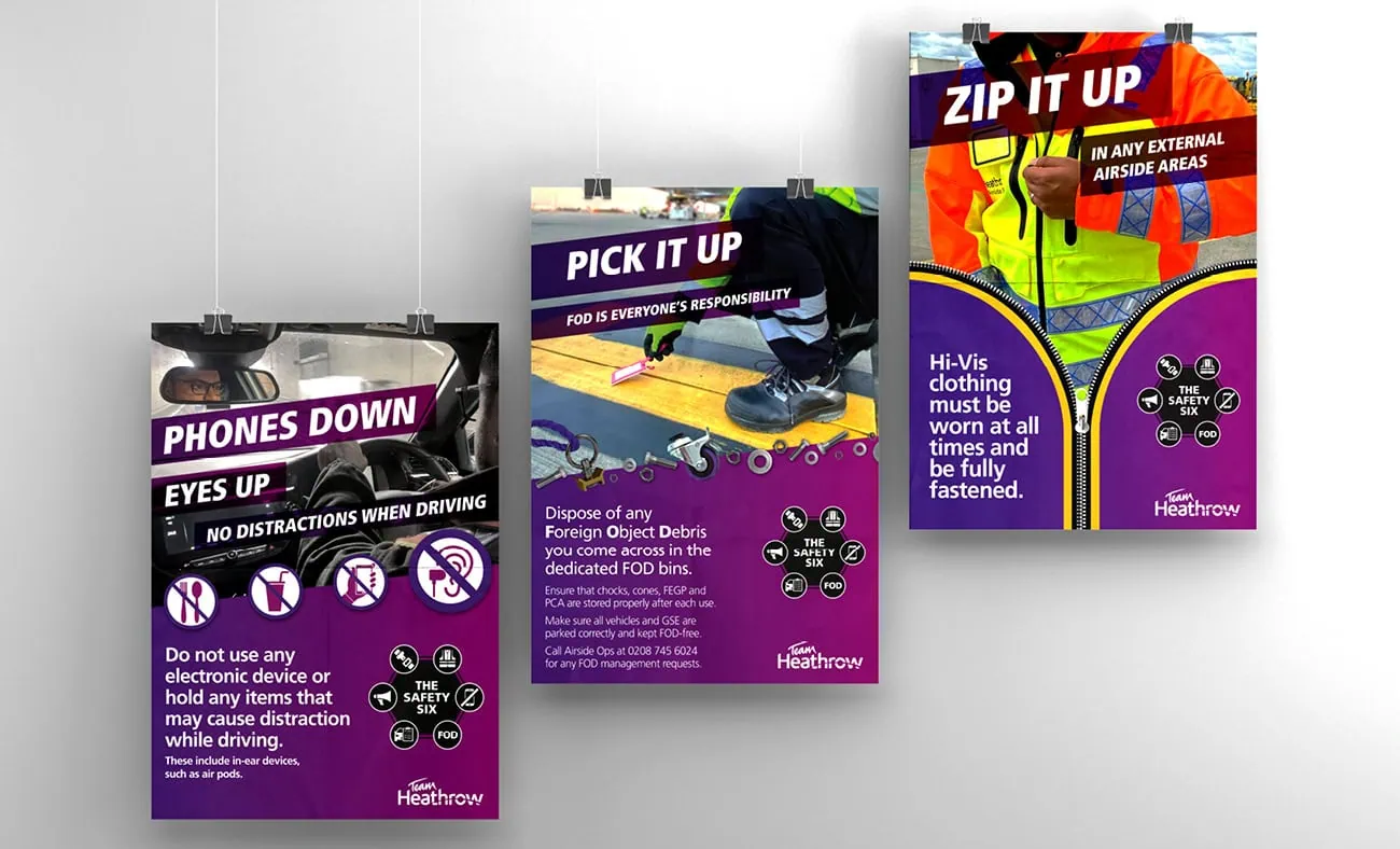 Three safety posters for Heathrow with purple backgrounds and bold headings: "PHONES DOWN, EYES UP", "PICK IT UP", and "ZIP IT UP".