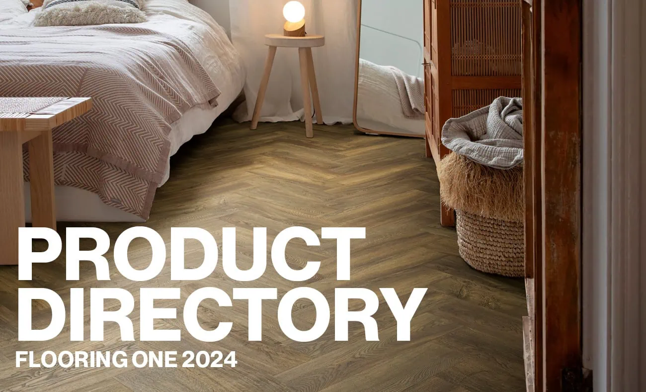 A cozy bedroom scene featuring herringbone wood flooring with the text "Product Directory: Flooring One 2024" prominently displayed in bold white letters.